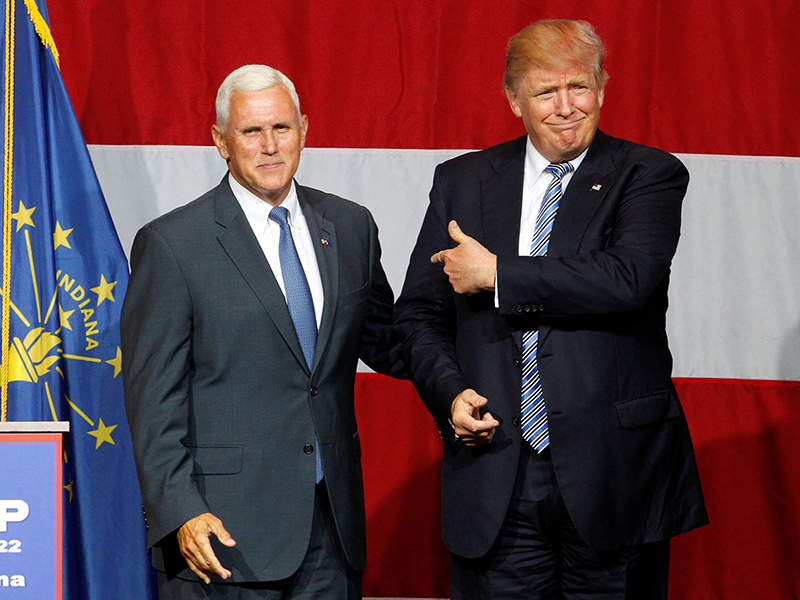Republican presidential candidate Donald Trump and Indiana Governor Mike Pence wave to the crowd before addressing the crowd during a campaign stop at the Grand Park Events Center in Westfield